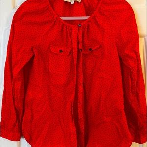 Orange button up blouse.